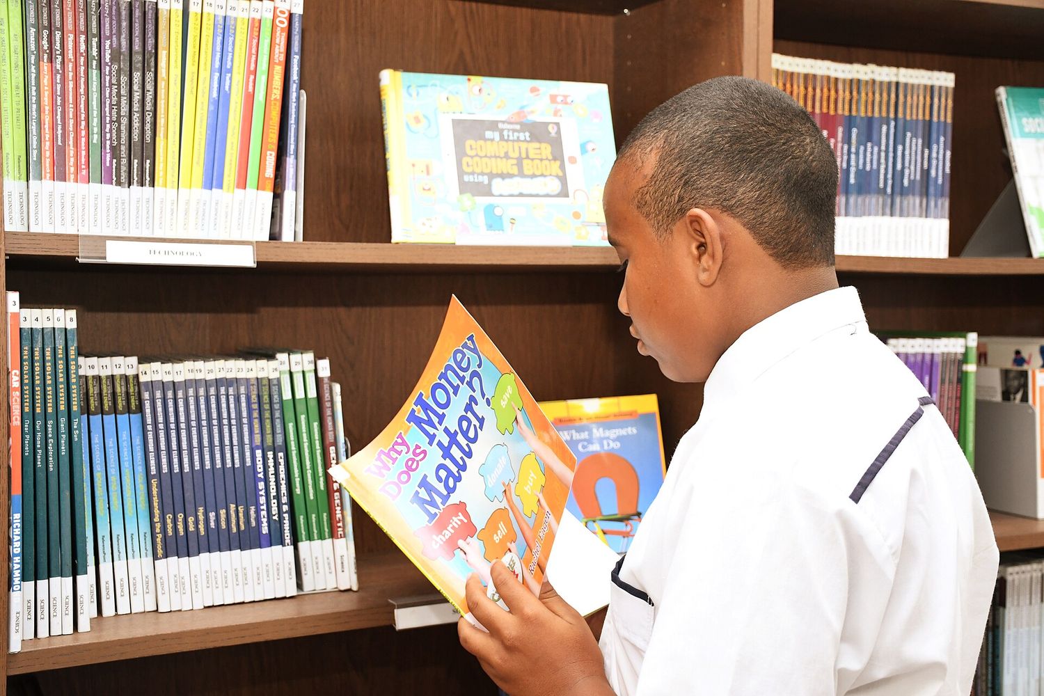 A pupil reading in the school library